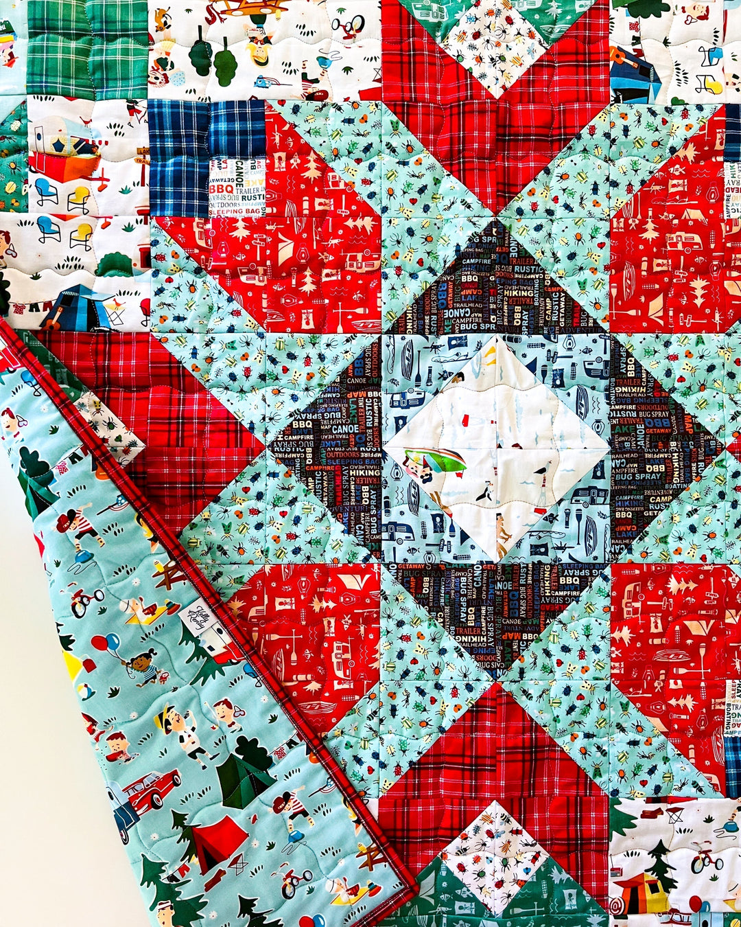 The Riley Blake Designs collection Happy Haven made with the First Bloom Quilt Pattern to make a nostalgic camping themed quilt