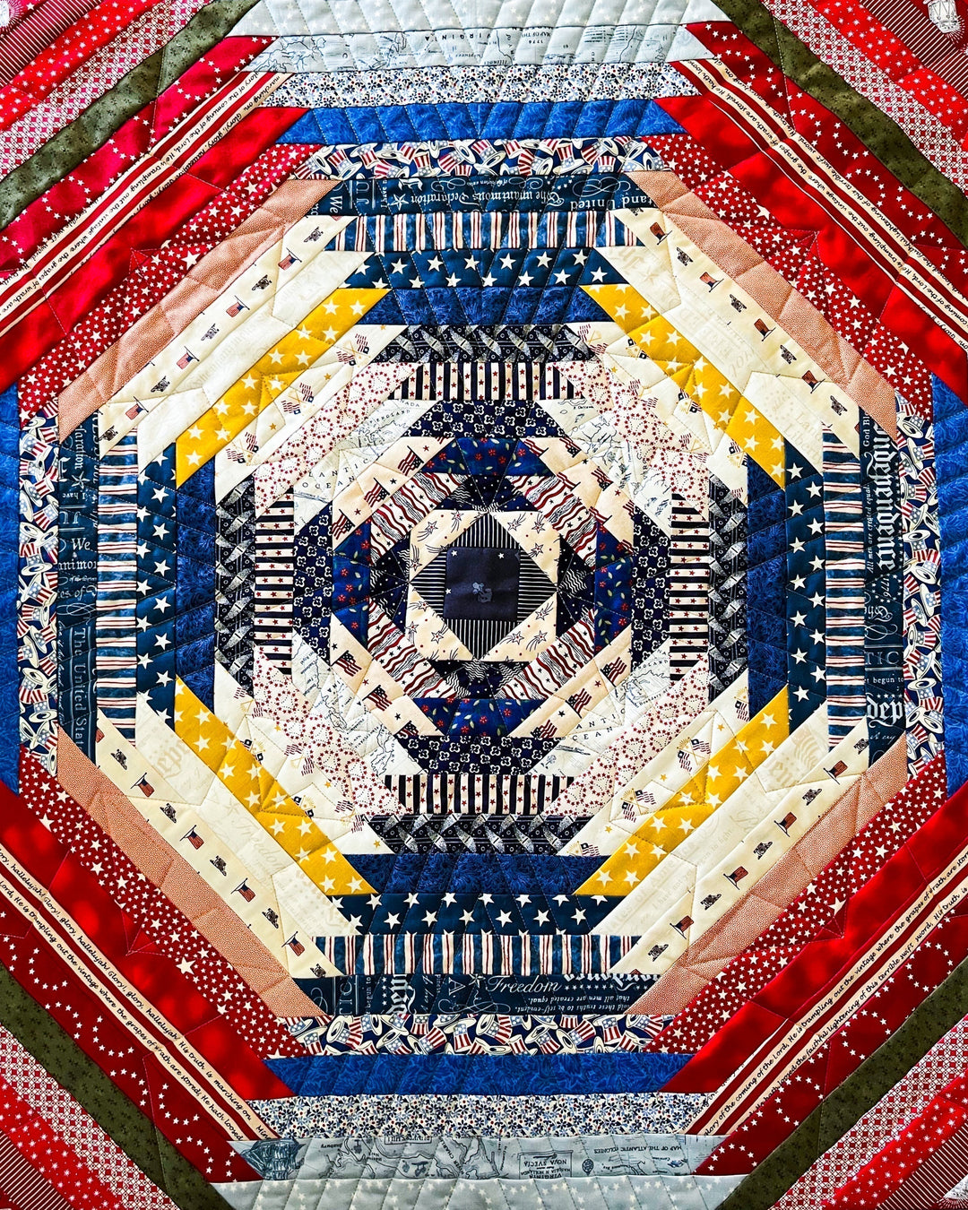 An Americana themed pineapple quilt made with the Supercolossal Quilt Pattern, with scrap fabrics