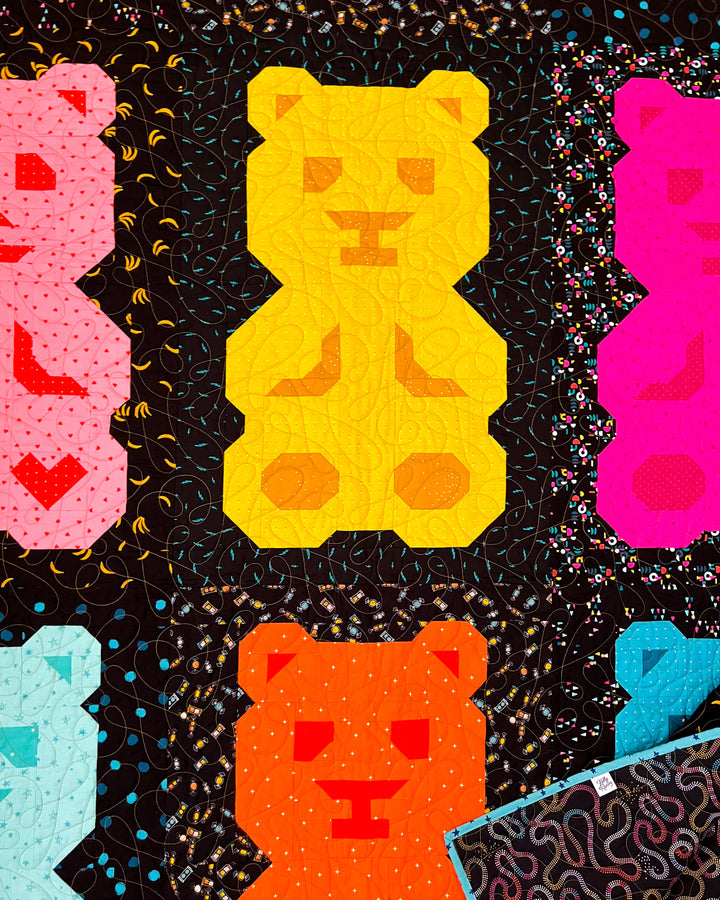 Beary Bunch, a colorful quilt pattern of bear-shaped blocks on a black background