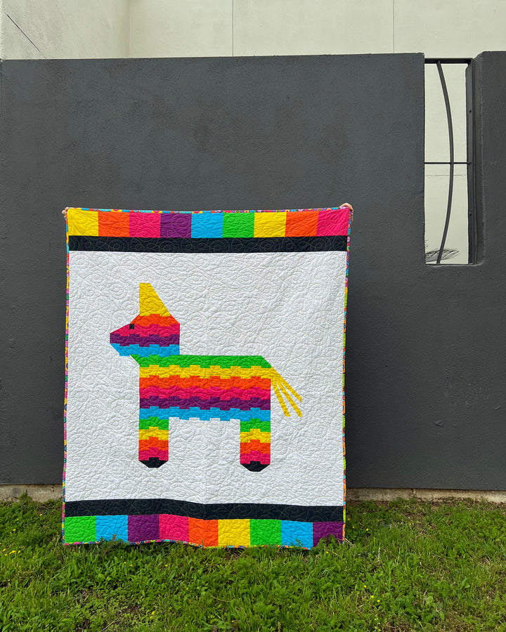 Henry the Pinata Quilt against gray gray wall