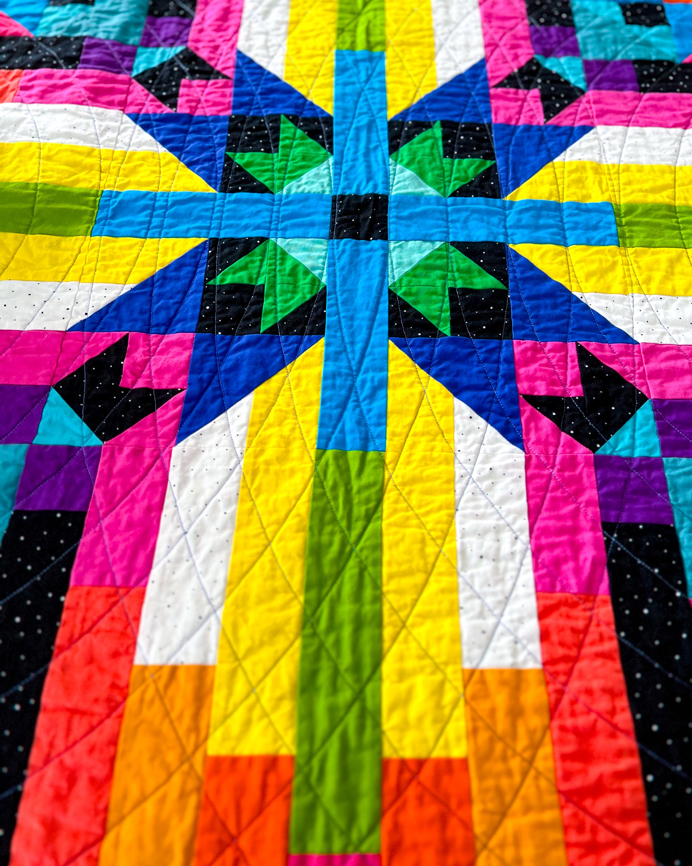Converging Paths, a colorful quilt with geometric pattern